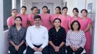 Male doctor and hospital workers in group posing for the camera.
